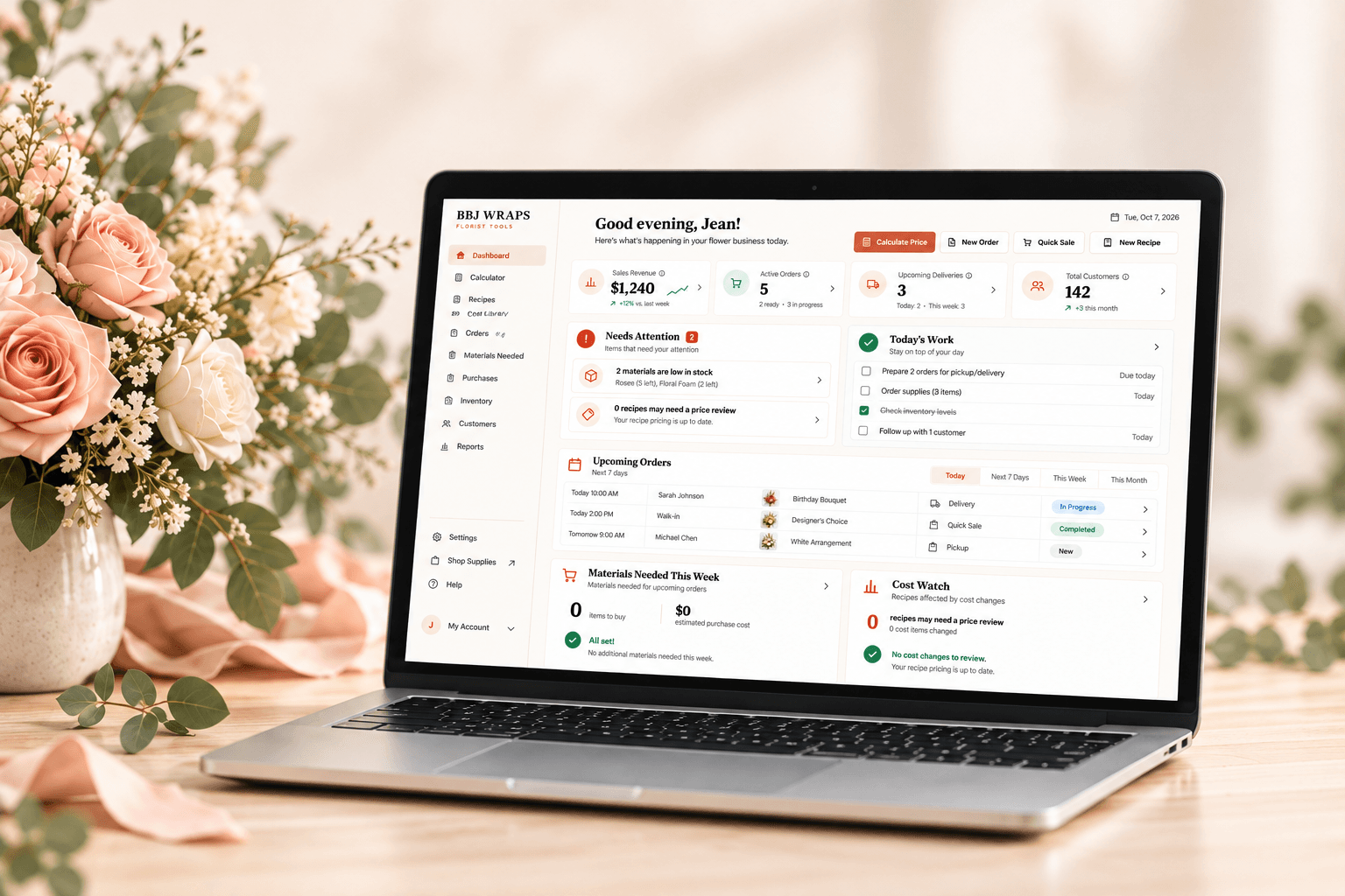 A florist workspace with peach roses and a laptop showing the BBJ WRAPS Florist Tools dashboard